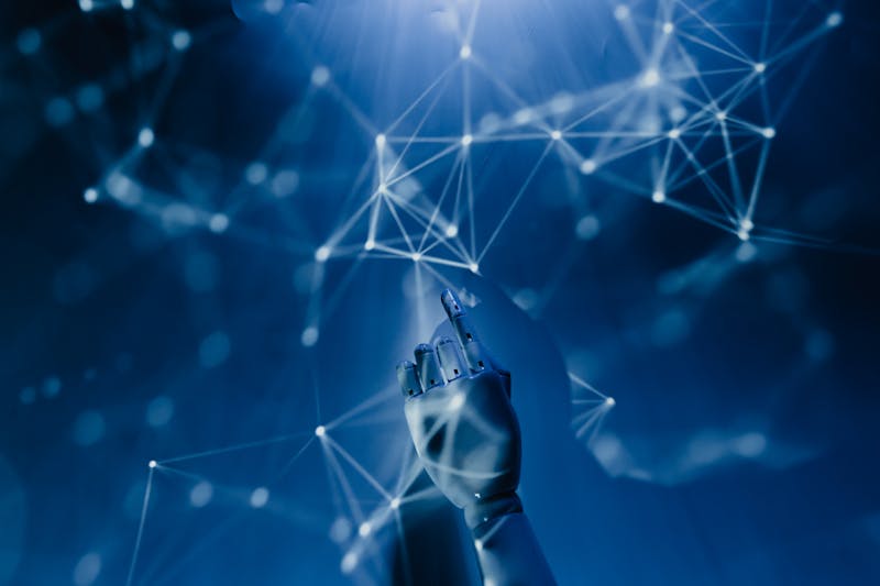 Artificial intelligence robotic hand reaching into connected network nodes